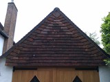 Verticle tiling to the gable end of the garage with Winchester cuts to the underneath of the gables. Gable ends run with black cement mortar onto cement undercloaks